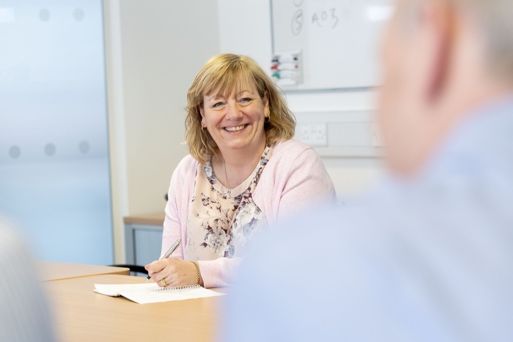People sitting round table during meeting